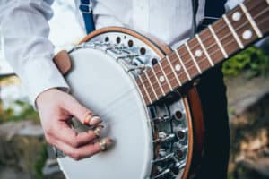 Fingerpicks scraping the banjo head surface